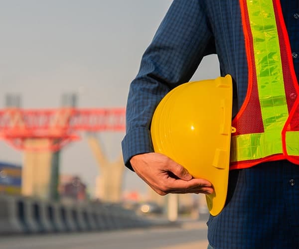 Facility Manager Standing With Engineer's Cap